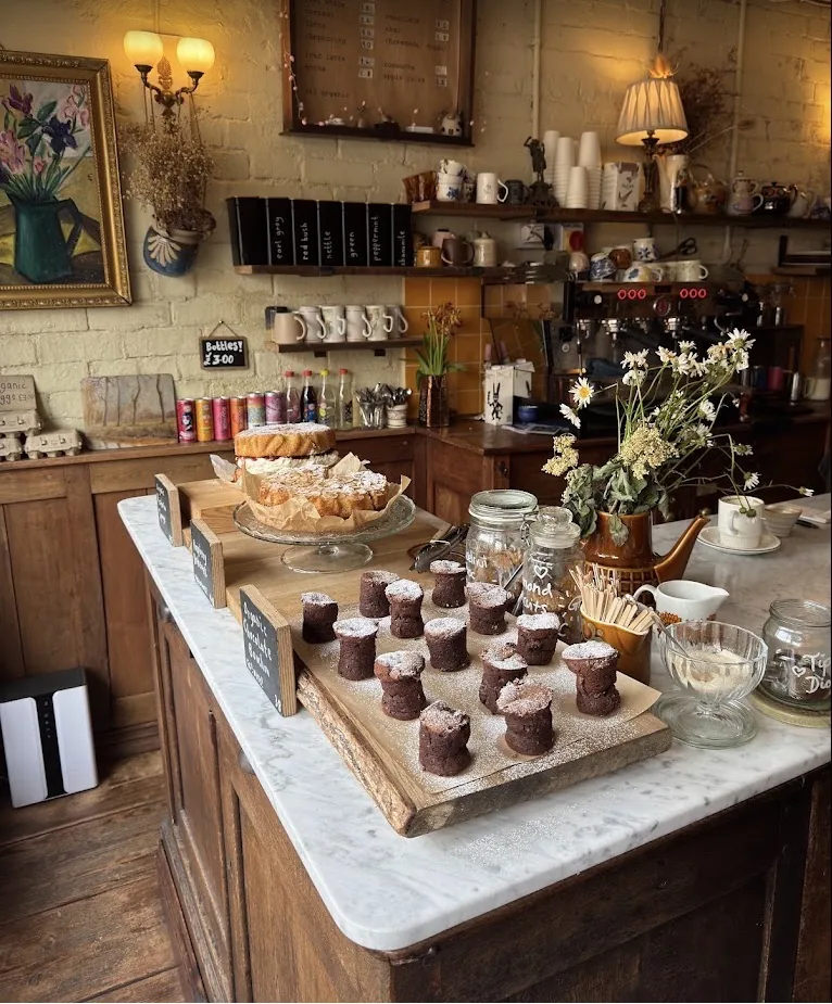 Wide view of the Wardrobe counter with cakes and coffee equipment